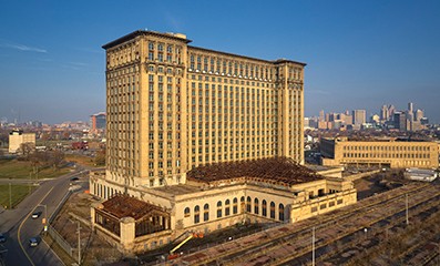 Michigan Central Station at night lit up with blue lights